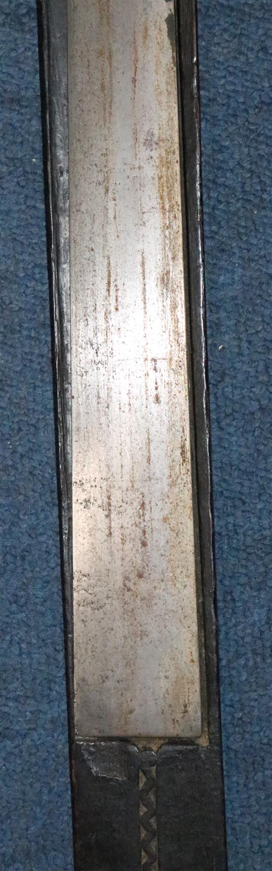 A Naga Dao sword and hardwood scabbard, Assam. 19th century, total length 114.5cm (45in.)
